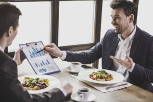 men talking about business over lunch on their vacation