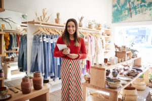 small business owner standing in front of her merchandise